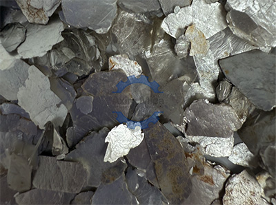 Silver alloy with mica flakes, showcasing a shimmering texture ideal for jewelry design and craftsmanship.
