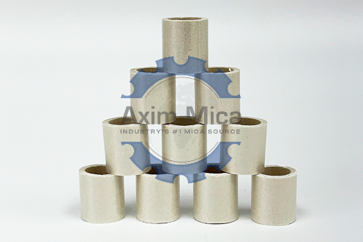 Different types of metal pipes and fittings, featuring mica tubes, arranged for inspection on a flat surface.